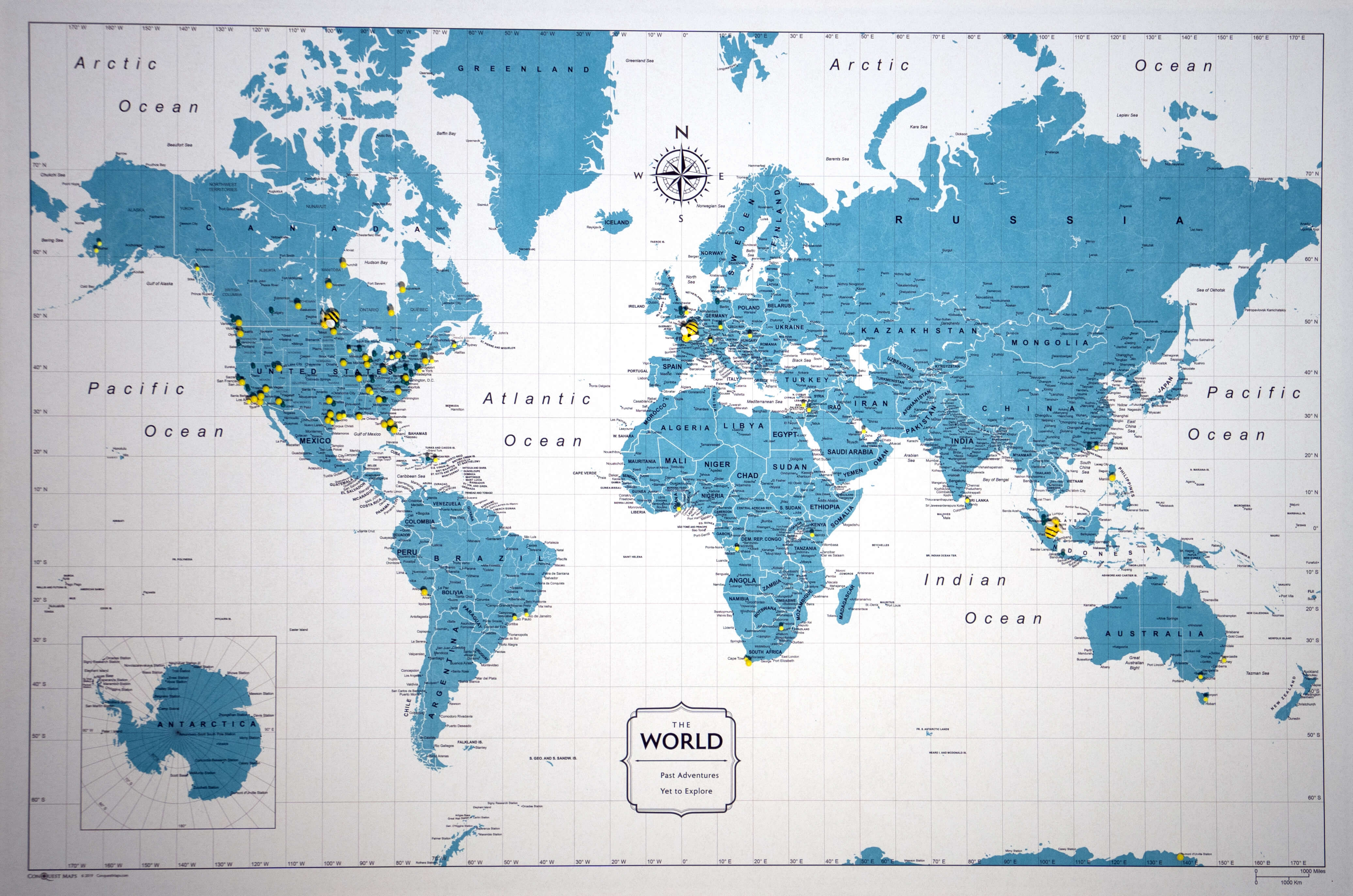 blue and white world map with yellow pins in it